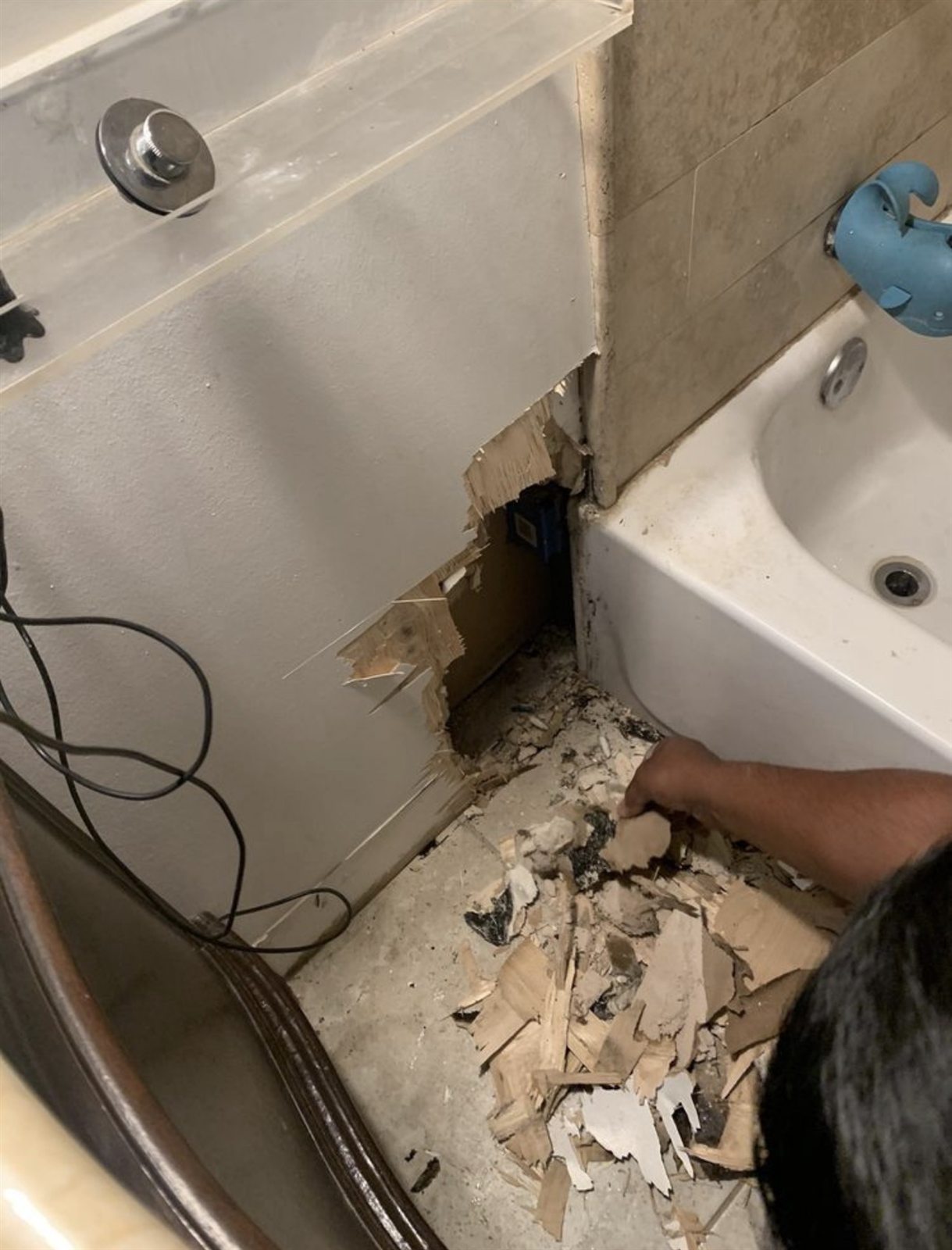 Water-damaged drywall cut out, before repair